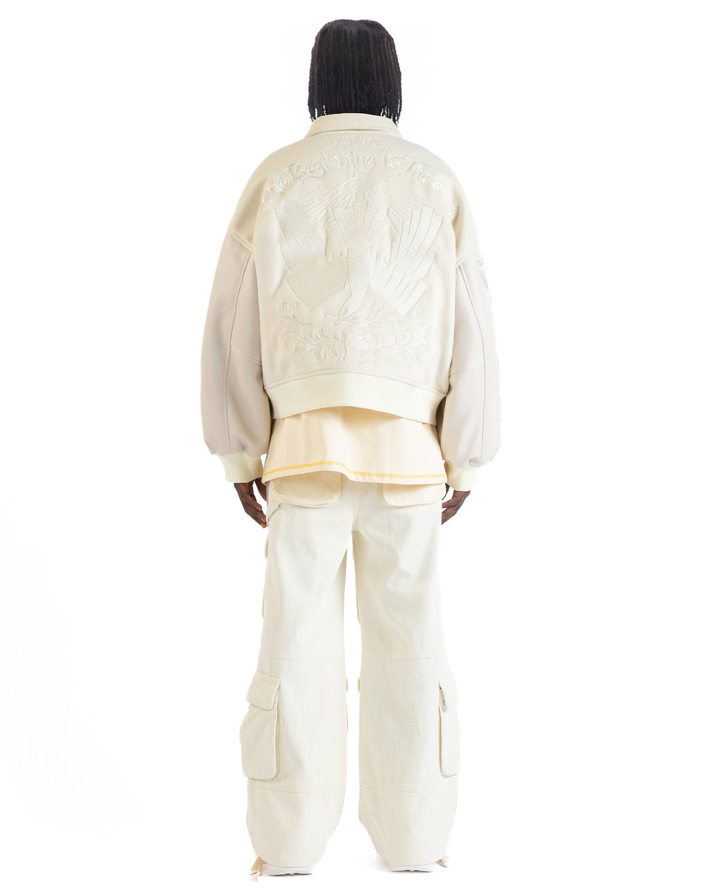 Untitled Artworks “Angel of Peace” varsity jacket in white with peace symbol embroidery and patches, oversized fit. back facing on model 