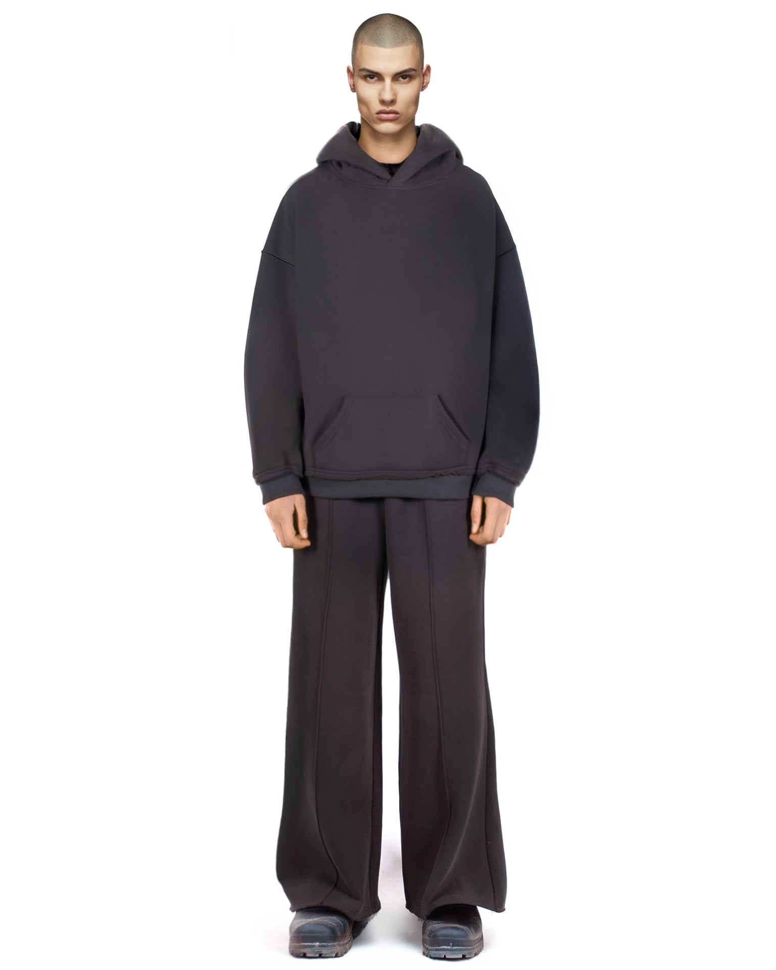 Untitled Artworks Essential Hoodie in Black – relaxed-fit cotton fleece pullover with kangaroo pocket and raw-edge details. on model