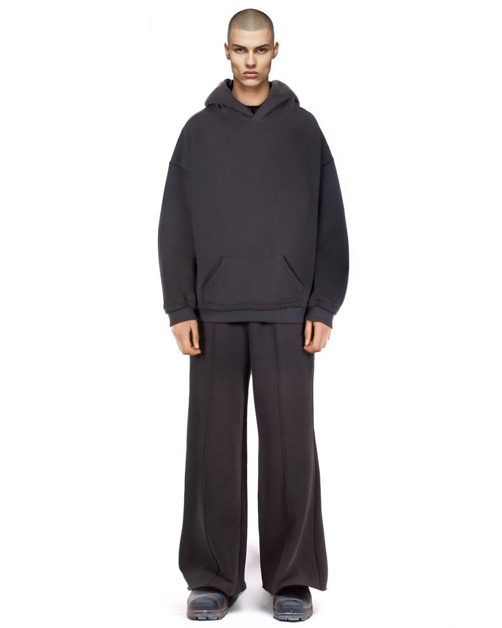 Untitled Artworks Essential Hoodie in Black – relaxed-fit cotton fleece pullover with kangaroo pocket and raw-edge details. on model
