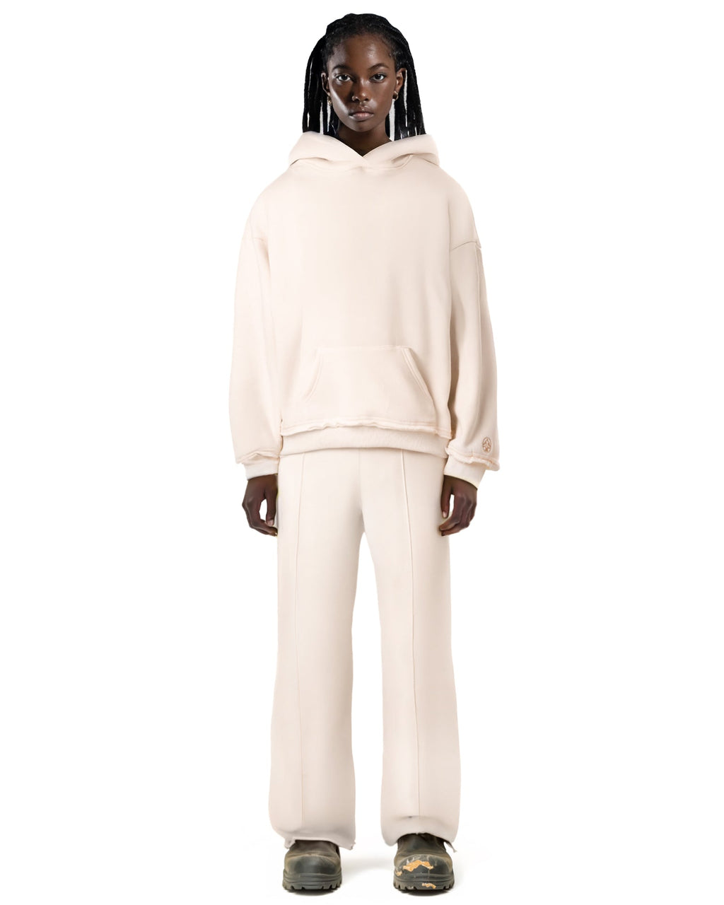 Untitled Artworks Essential Hoodie in Canvas (off-white) – relaxed-fit fleece hoodie with raw hem details and kangaroo pocket. on model