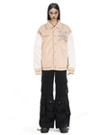 Untitled Artworks “Hunting Oat” varsity jacket in tan (oat) with embroidered hunting graphics and oversized letterman fit. on model front 