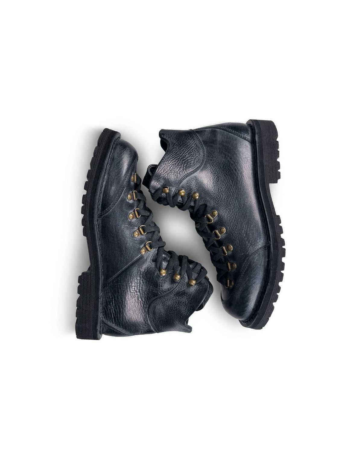 Close-up top down view of the Untitled Artworks x Fracap Destroyer Boot in black, showcasing its spray-effect finish, oversized fold-over tongue, and antique brass eyelets.