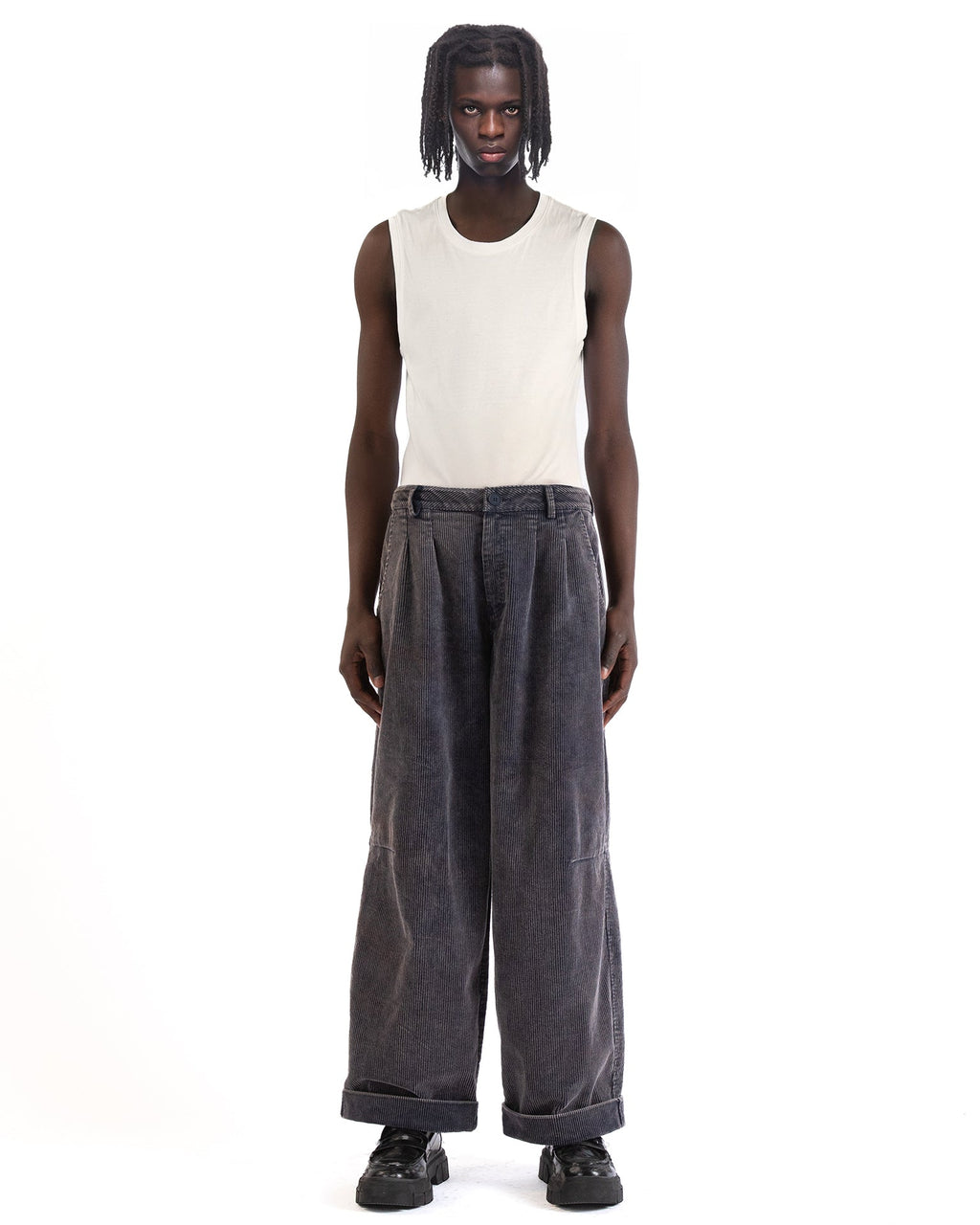 Front view of the blue corduroy pants showing the wide-leg cut and pleated front