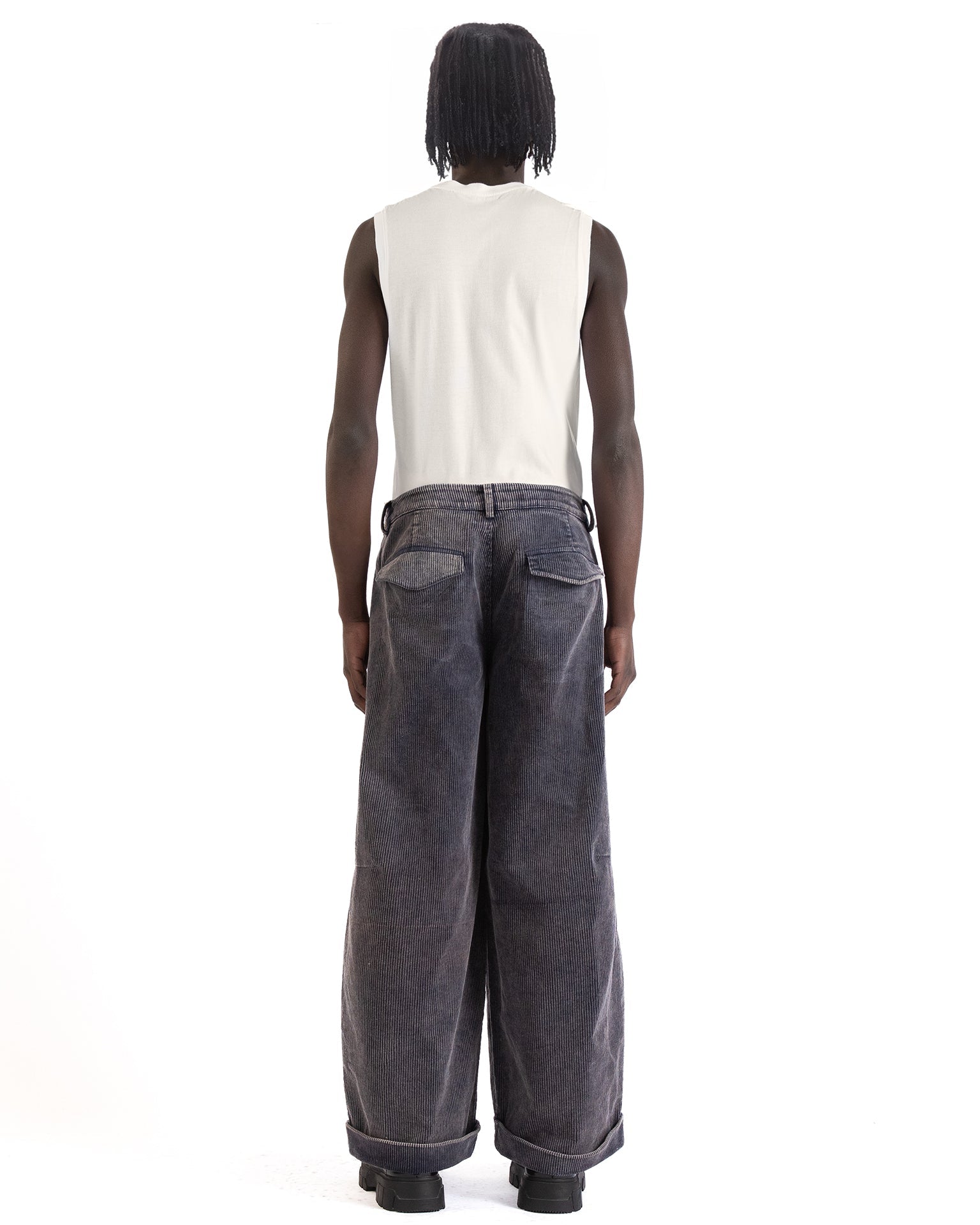 Back view with mid-rise waist and flap pockets