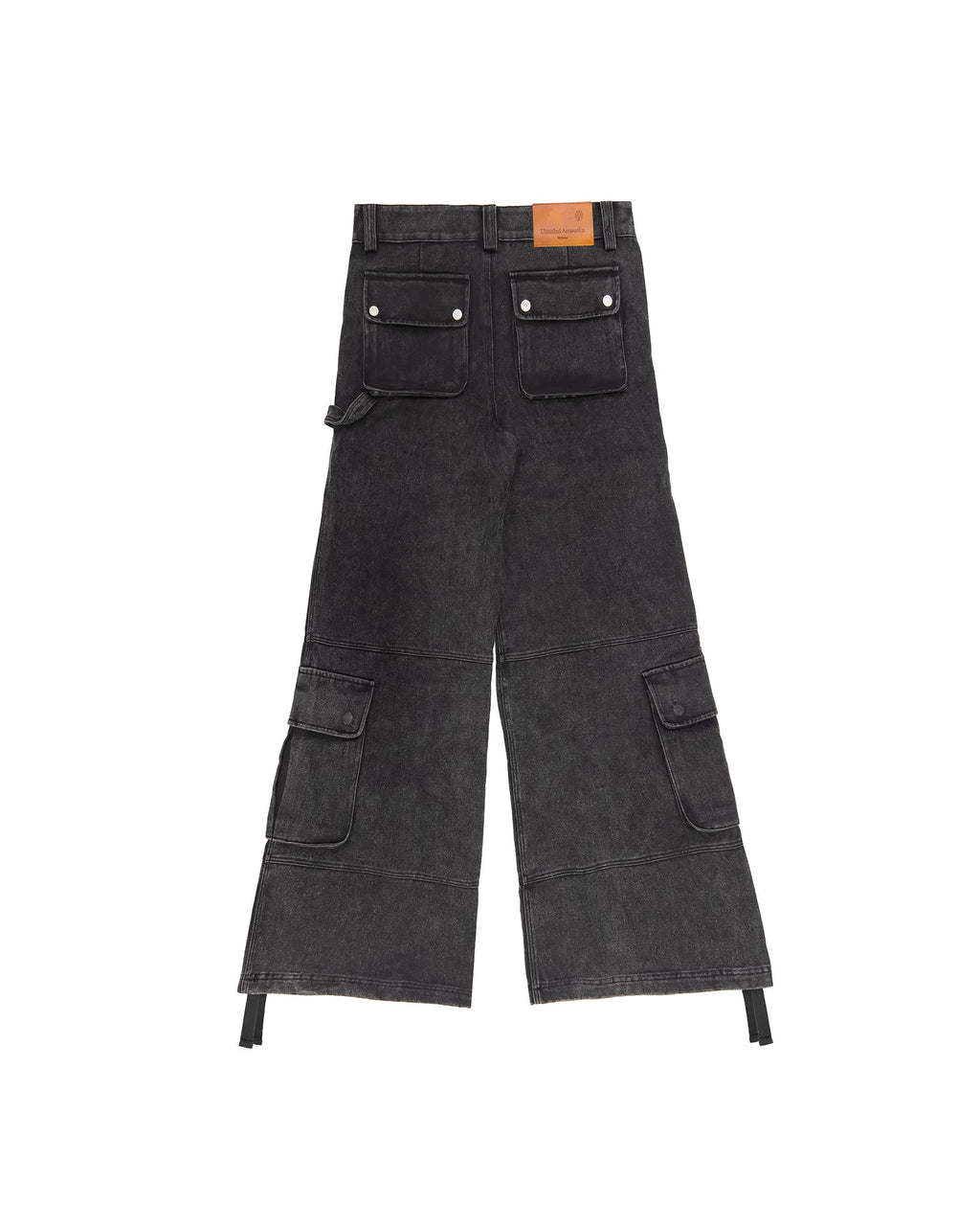 Model styled in the washed black cargo pants demonstrating the wide-leg cut in a streetwear look.
