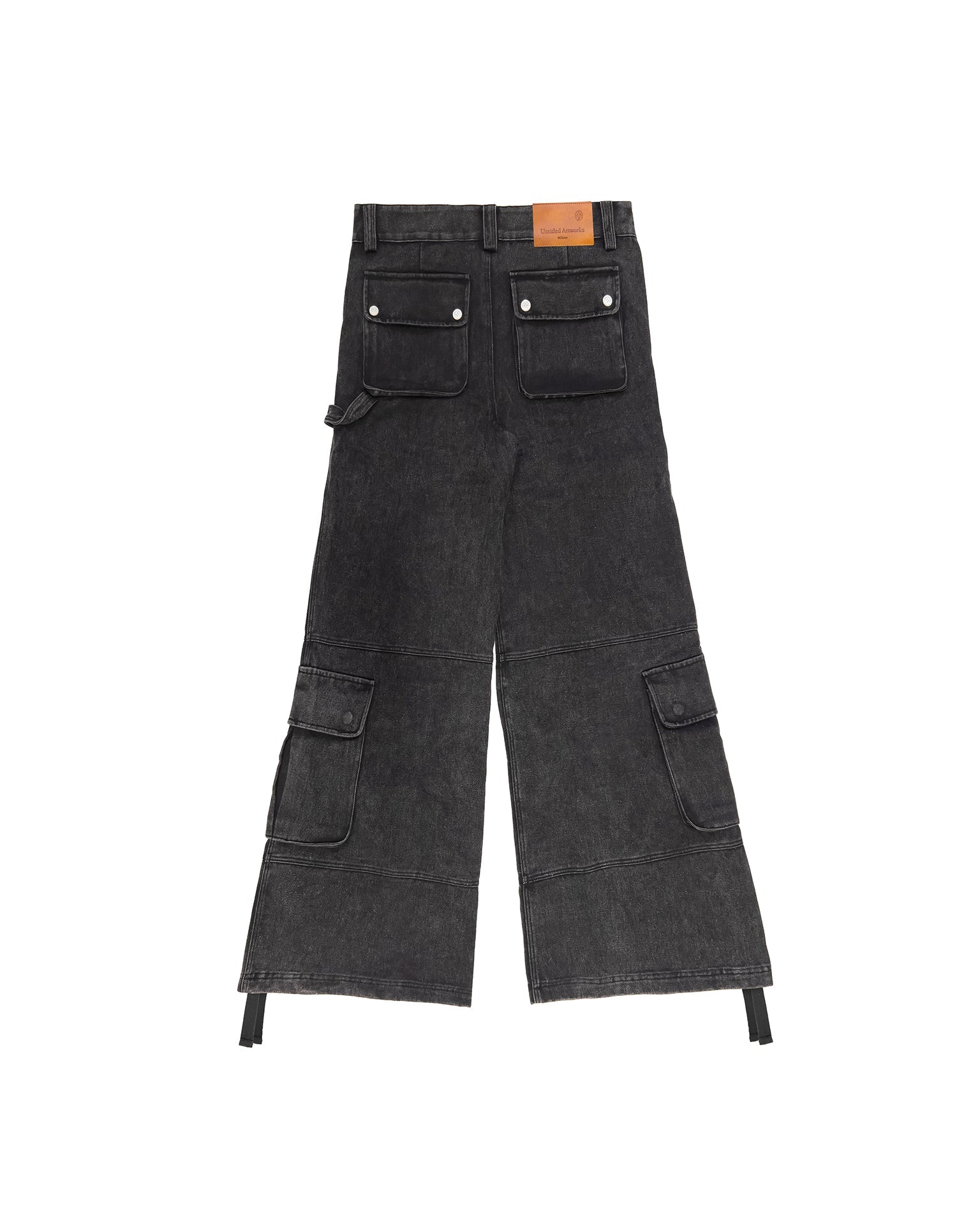 Model styled in the washed black cargo pants demonstrating the wide-leg cut in a streetwear look.